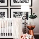 a colorful contemporary nursery with a white crib, a chair, a rattan stool, an emerald sideboard, colorful bedding and an artwork