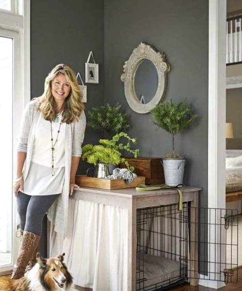 a cozy and private dog crate with curtains doubles as a plant stand and matches the vintage farmhouse style of the space