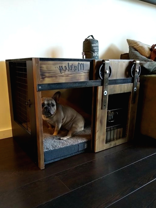 a stained wood and blackened metal dog crate with a sliding door is a cool solution for an industrial or rustic space