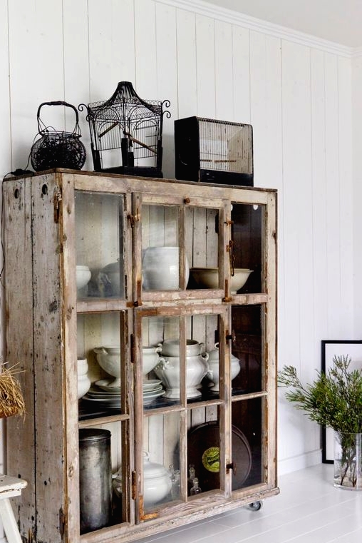 a whitewashed and brushed shabby chic storage unit with sliding glass doors is a very pretty and cool idea