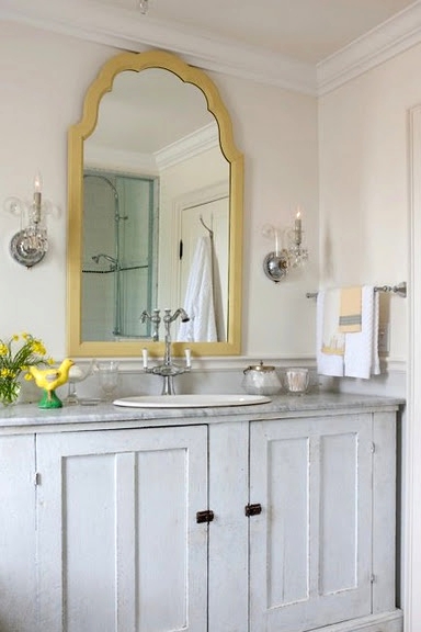 a shabby chic whitewashed bathroom vanity with a stone countertop and a vintage faucet is a very chic and stylish idea to rock