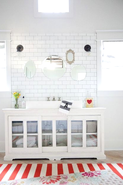 a white vintage sideboard as a bathroom vanity, with glass doors and baskets for storage is a lovely idea for a modern space, too