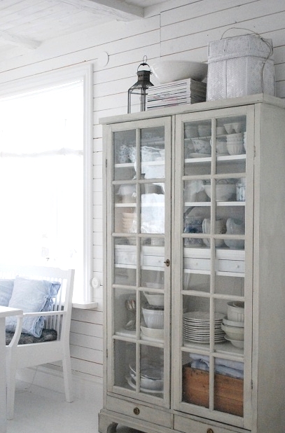a pretty whitewashed glass cupboard like this one will give you storage and display at the same time and it looks very airy and lightweight