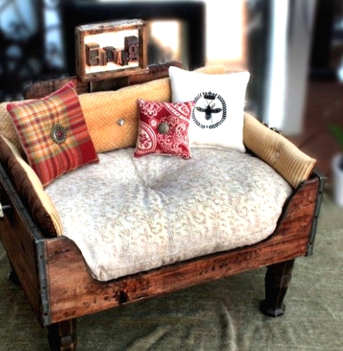 a rich-stained drawer put on legs, with a cushion and some pillows is a lovely idea for a rustic home