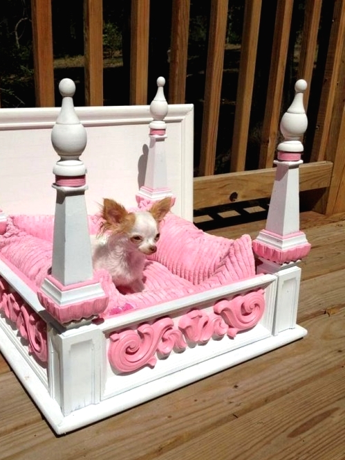 a glam dog bed with pillars, with a pink cushion and pink detailing is a very stylish and chic idea for a glam home