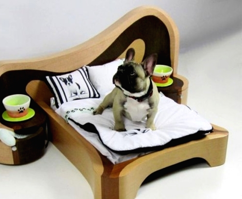 a catchily shaped plywood dog bed with a headboard and additional nightstands with bowls is a fun idea