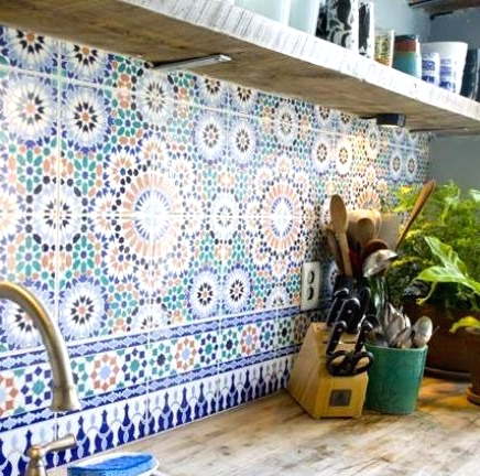 a colorful and patterned tile backsplash done in green, rust and navy is a lovely idea for a modern and neutral space