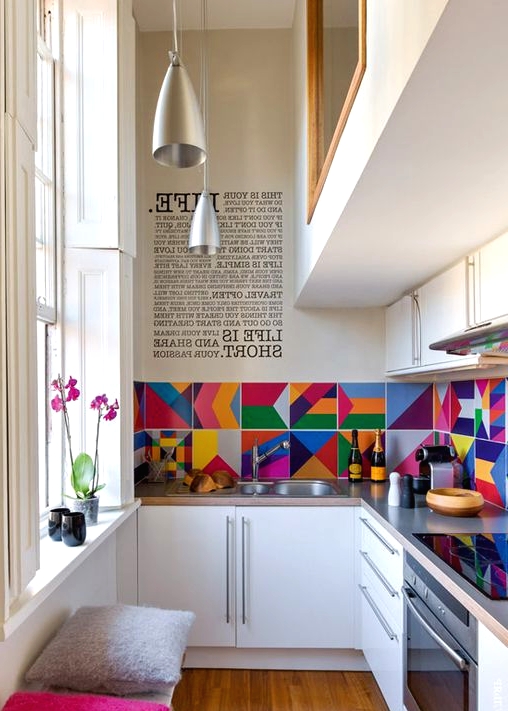 a modern white kitchen with grey countertops, a colorful tile backsplash, pendant lamps and colorful stools is a lovely idea