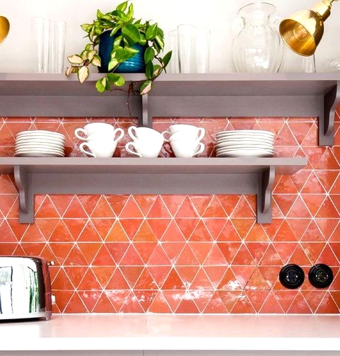 a super bold orange geo tile backsplash is a bold solution for a modern kitchen, it will add much color to the space