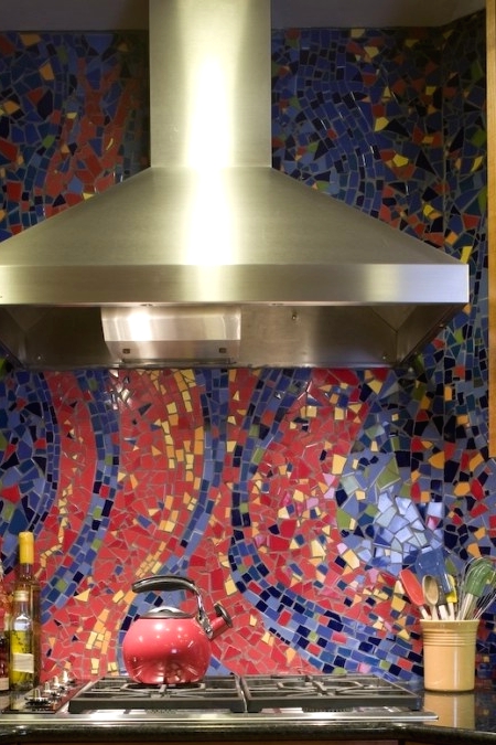 a neutral traditional kitchen with black countertops, a super colorful blue, yellow and coral mosaic tile backsplash is a very fun and cool idea