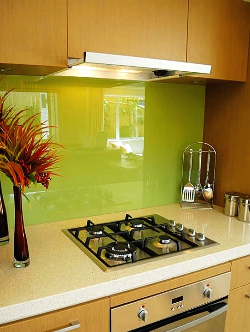 a light-stained kitchen with modern handles, with a super bold neon green glass backsplash is a colorful and bold idea