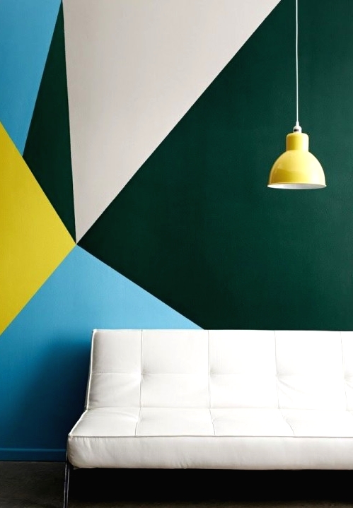 a colorful and contrasting geometric print accent wall, a white leather couch for a contrast