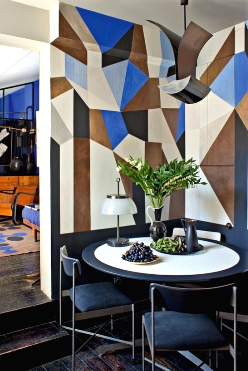 a chic bright geometric wall in blue, brown and neutrals that takes over the whole space and accents it a lot