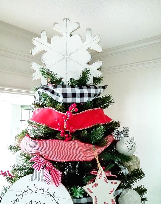 a large white plywoof snowflake tree topper is a perfect match for this cool and bright farmhouse Christmas tree