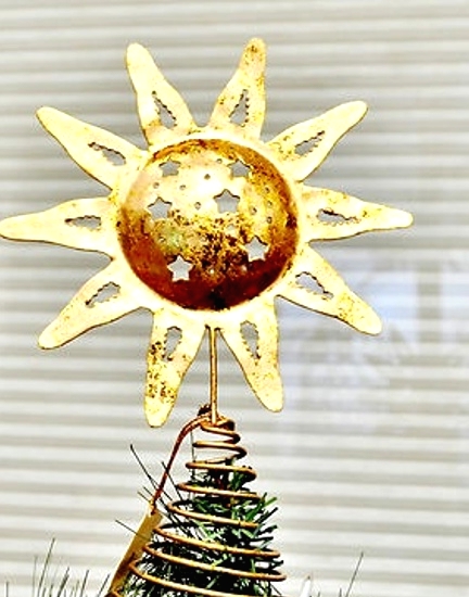 an oversized gold sun with stars tree topper is a shiny and glam Christmas tree accessory that will make a statement