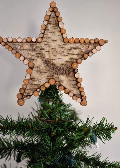a tree bark star tree topper with small branch slices is a lovely rustic Christmas tree decoration