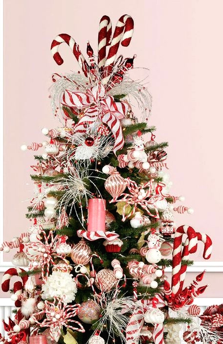 a peppermint styled Christmas tree topped with oversized candy canes is a perfect idea for a playful and super fun Christmas space
