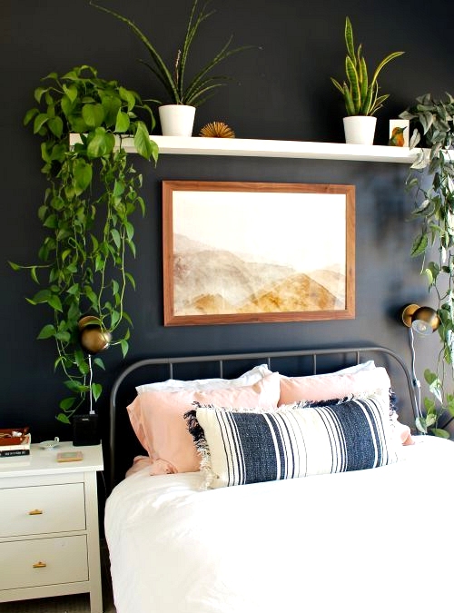 A beautiful boho bedroom with a black accent wall.