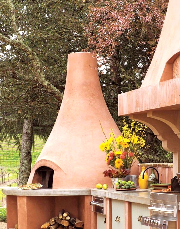 Outdoor kitchen design with a huge clay pizza oven